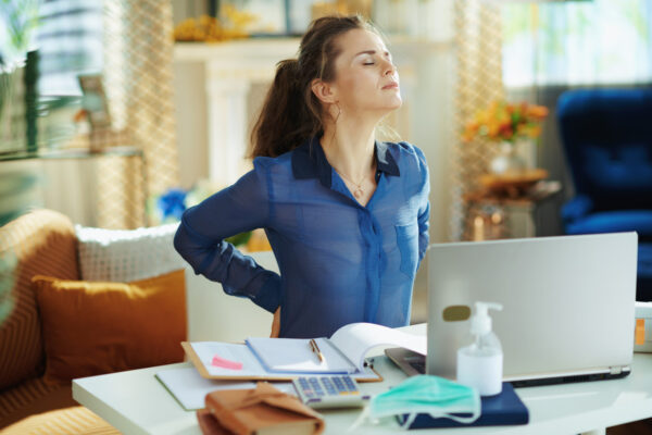 woman with pain in her back using TENS