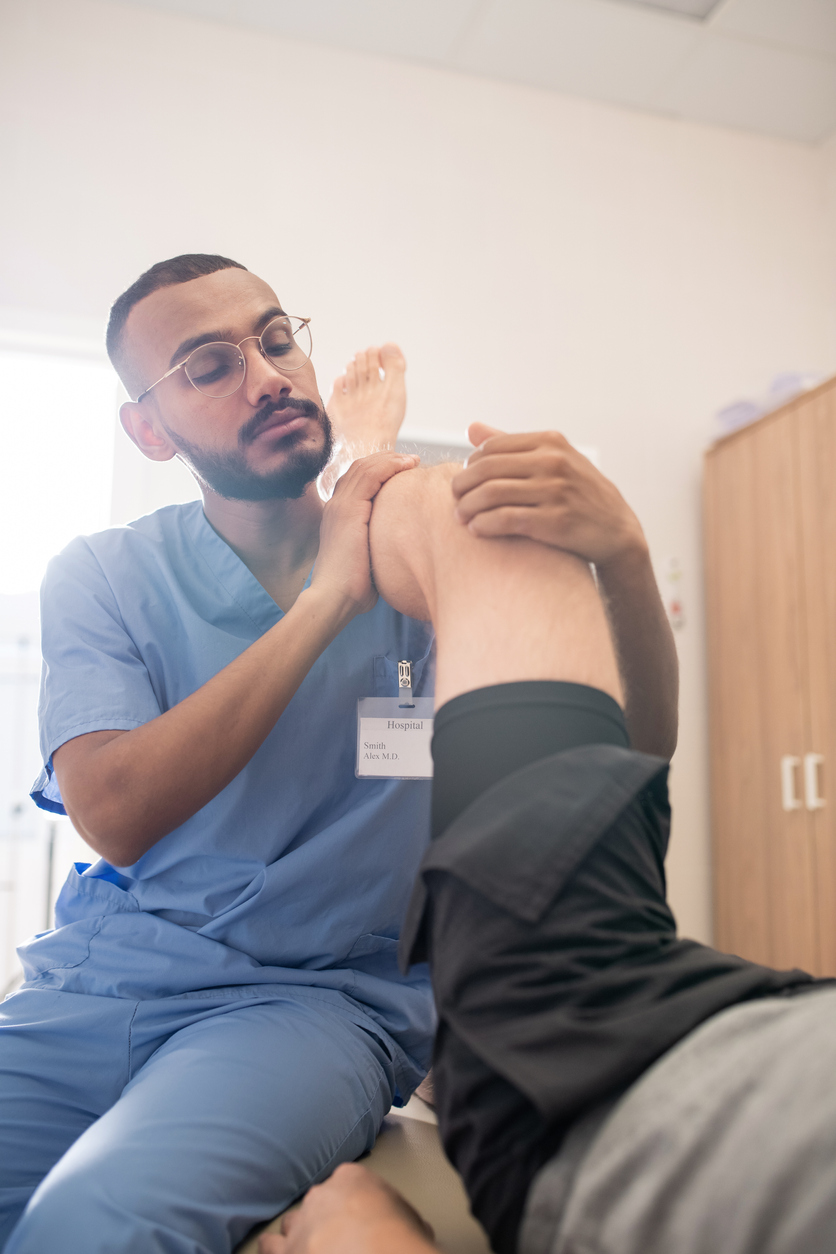 pain management doctor working with patient